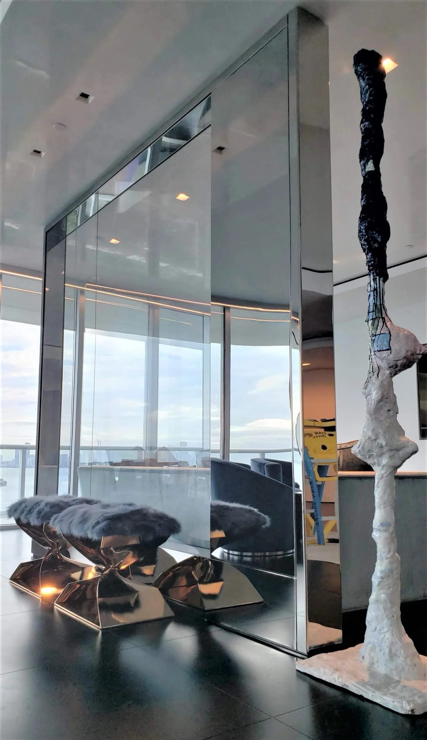 Floor-to-ceiling glass partition in a blackened stainless frame