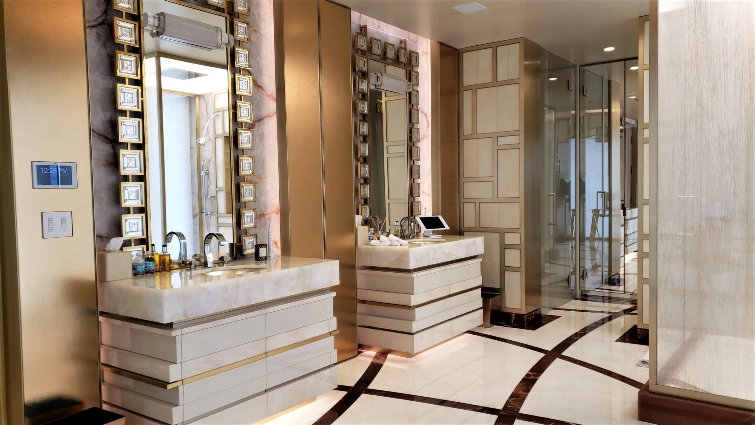 Bathroom vanities and mirrors framed in brass