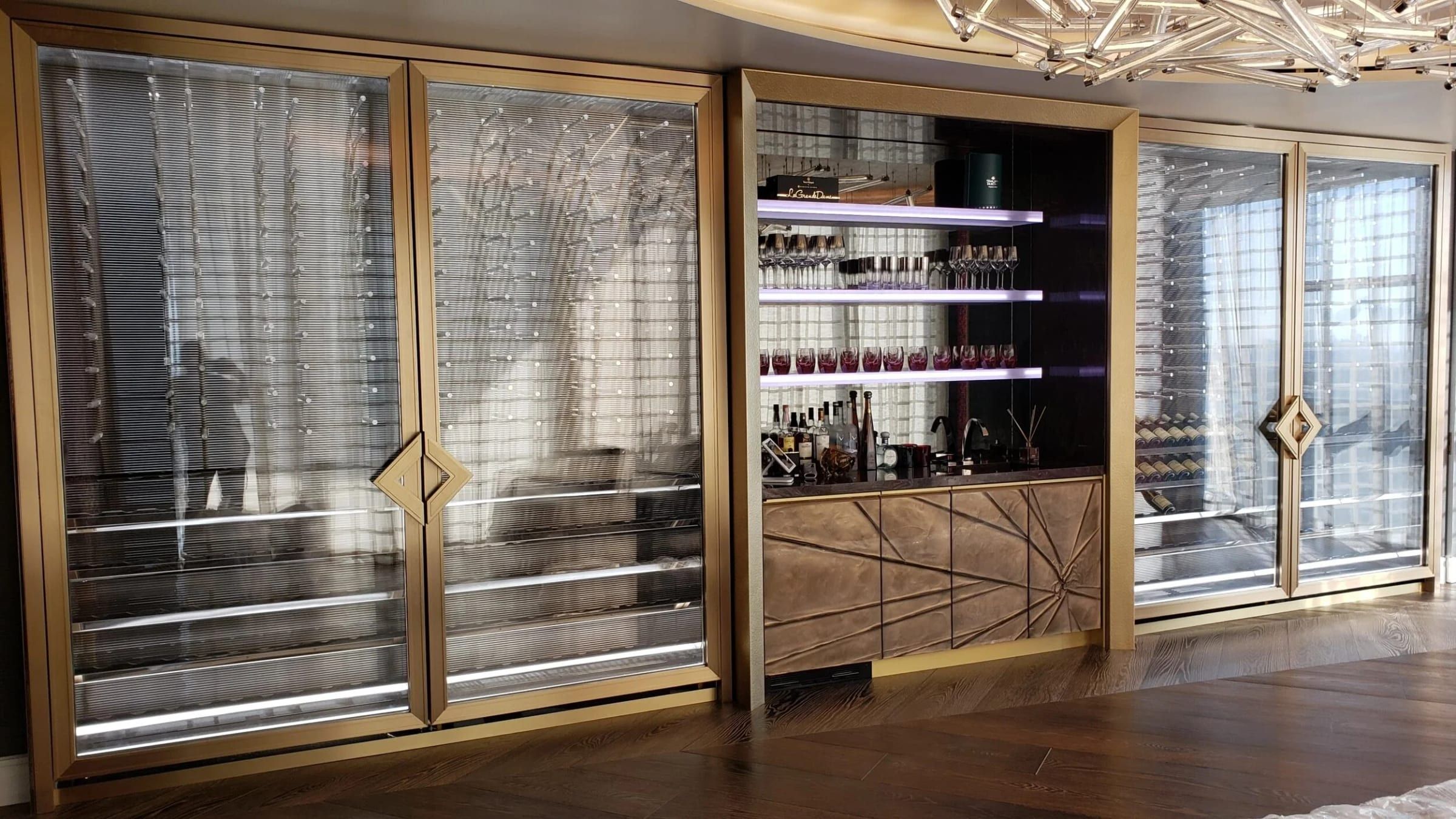 Wine wall behind brass-framed glass doors
