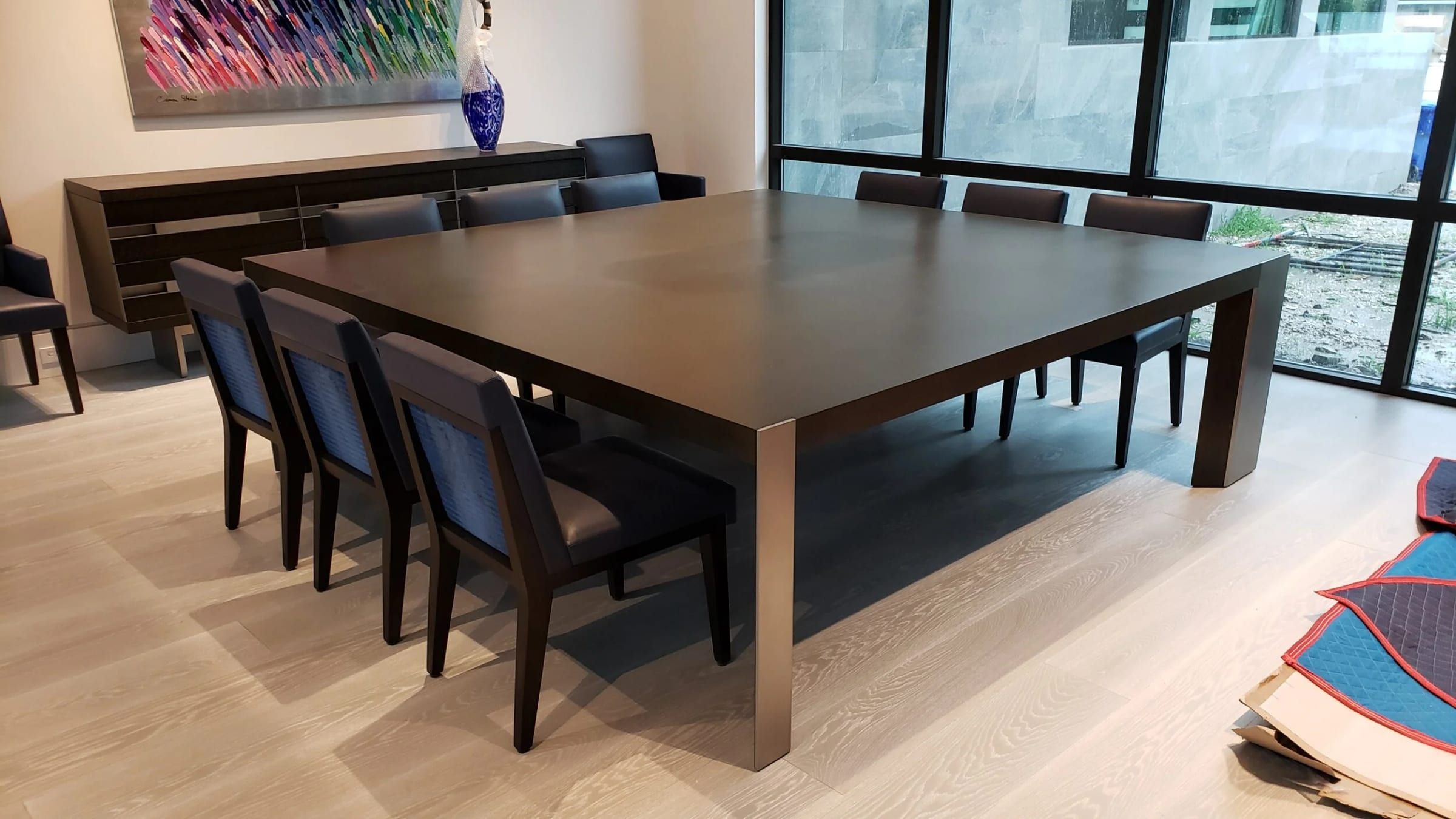 Dining table with a dark metal-clad base