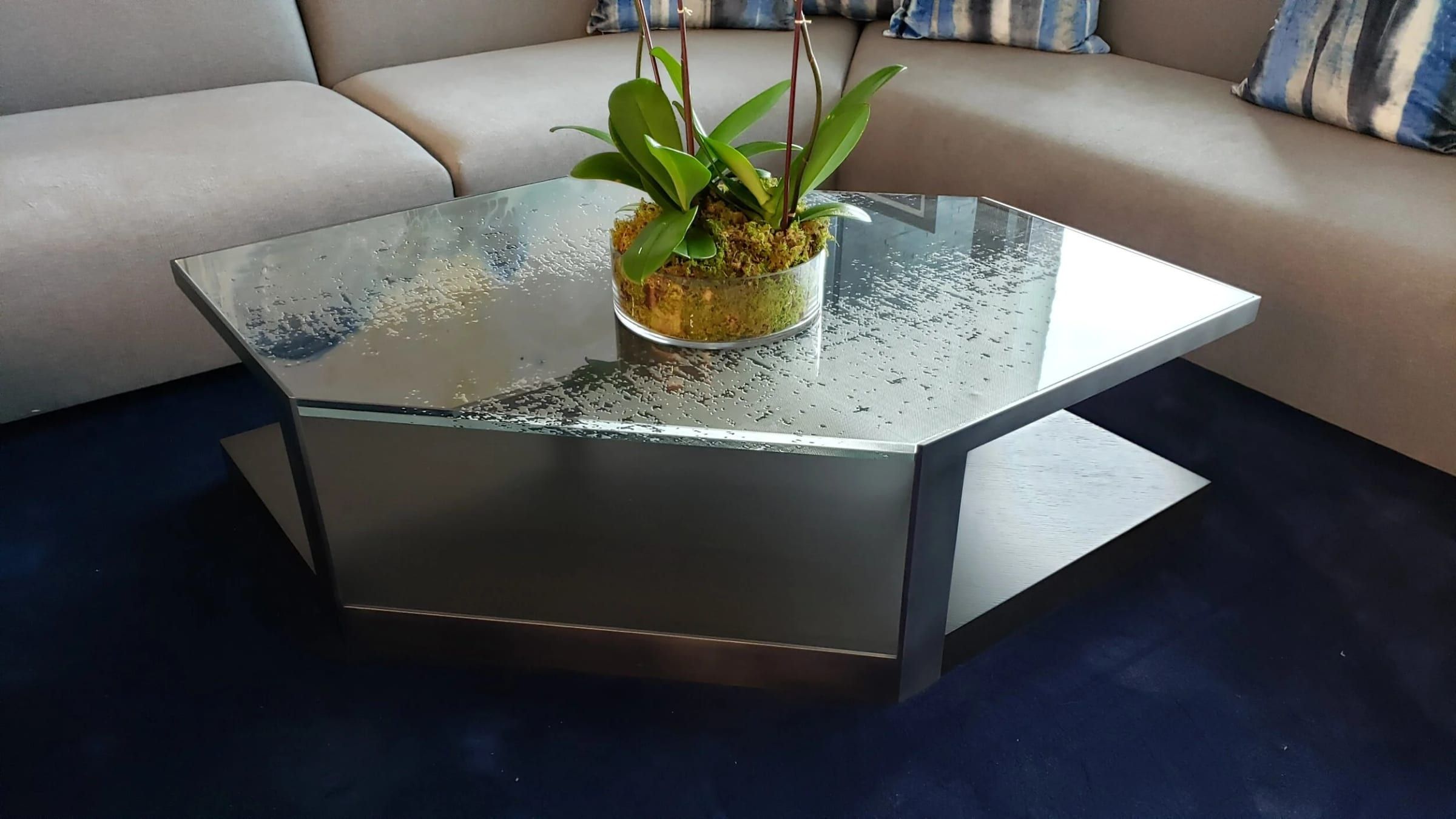 Glass-topped coffee table on a brushed metal base
