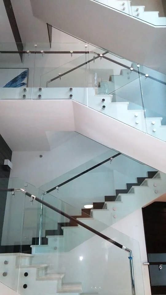 Glass balustrades on a staircase rising three floors